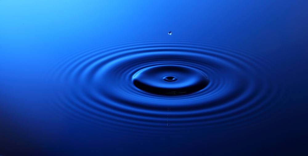 Drop of water falling into the water and leaving it circles.